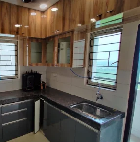 Kitchen sink run set beneath a window with daylight across the granite counter